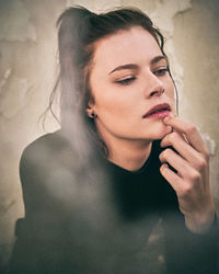 Portrait of beautiful young woman looking away