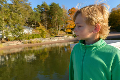 Portrait of boy looking at lake