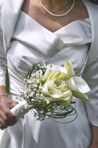 Midsection of woman holding bouquet