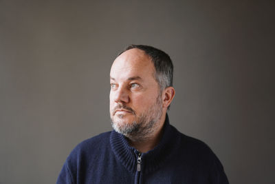 Portrait of man against black background