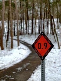 Road sign on snow covered land