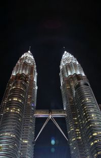 Low angle view of illuminated buildings against sky at night