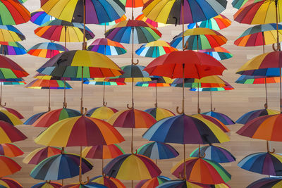 Multi colored umbrellas hanging in row