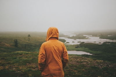 Rear view of man standing on mountain