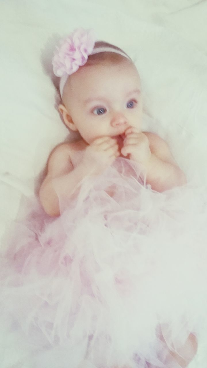 indoors, childhood, cute, high angle view, innocence, looking at camera, portrait, bed, toy, babyhood, white color, person, relaxation, baby, pets, elementary age, close-up, toddler