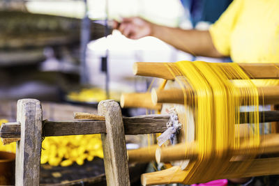 Craftsmanship. hand of woman weaving and spinning natural colorful threads or yarn.