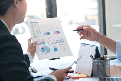 Cropped image of business people working in office