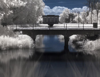 Reflection of building in lake against sky