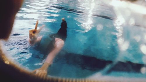 Reflection of woman swimming in sea