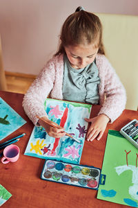 High angle view of girl painting at home