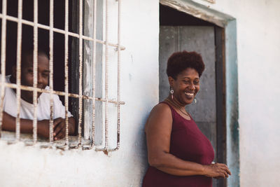 Portrait of smiling young man standing at home