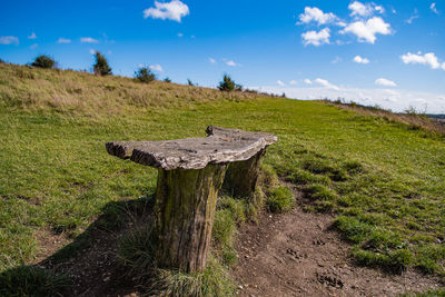 Wooden posts on field against sky