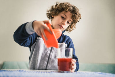 Mid adult man holding drink at home