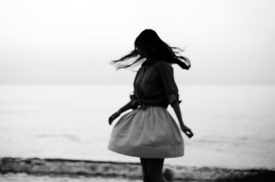 Rear view of woman standing in park