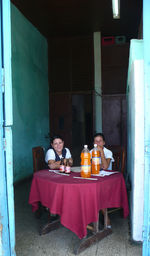 High angle view of people sitting on table