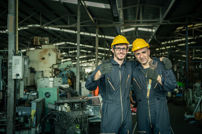 Portrait of smiling man standing in factory
