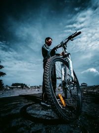 Man on bicycle against sky