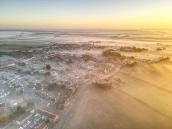 High angle view of city at sunset