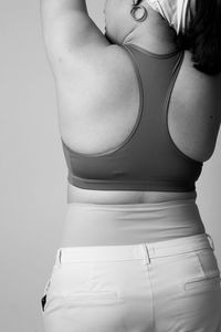 Rear view of woman standing against white background