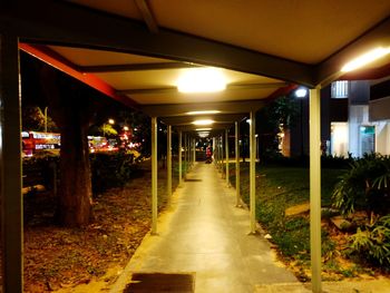 Empty corridor in illuminated building at night