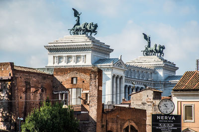 Low angle view of statue against historic building