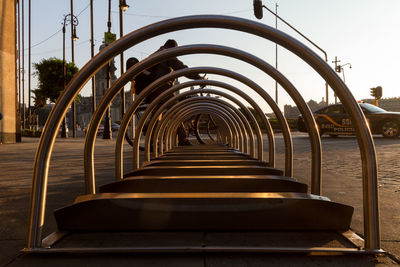 Person parking a bike at a bike rack in zócalo in mexico city, at dawn on empty streets