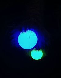 Close-up of illuminated light painting against black background