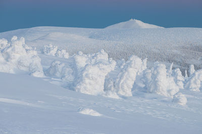 Scenic view of snow covered mountain against sky