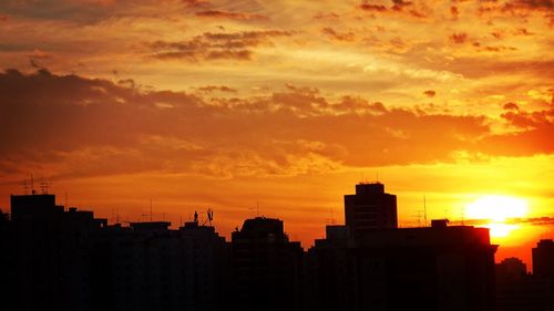 Residential district against orange sky