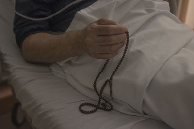 Close-up of hand holding cross
