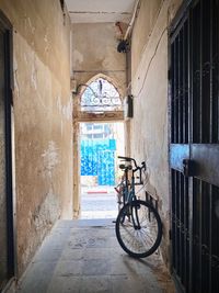 Bicycle in alley amidst buildings