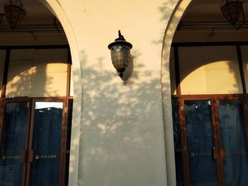 Low angle view of street light against building