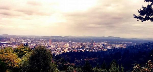 Cityscape against cloudy sky