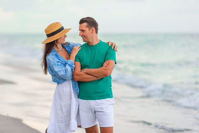 Side view of woman standing at beach