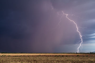 Thunderstorm lightning strike with dark clouds and rain near tucson, arizona