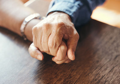 Cropped image of man holding hands