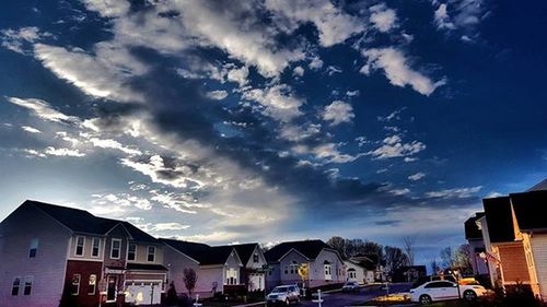 Buildings against cloudy sky