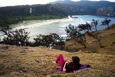 People sitting on grassy landscape