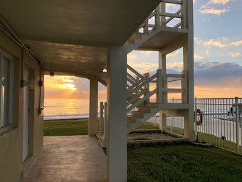 Bridge over sea against sky during sunset