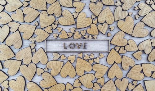 Directly above shot of text surrounded with heart shaped wood
