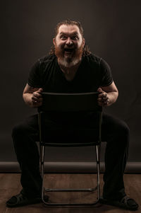 Portrait of man sitting on chair