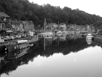 Boats in river with buildings in background