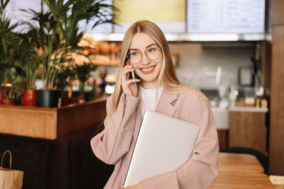  businesswoman entrepreneur with glasses looking at the camera in a public place in a cafe