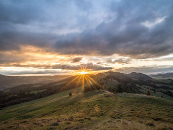 Scenic view of landscape against sky during sunset