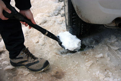 Low section of people holding snow