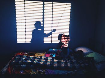 People sitting on bed at home