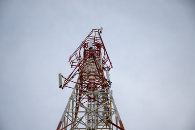 Low angle view of communications tower against sky