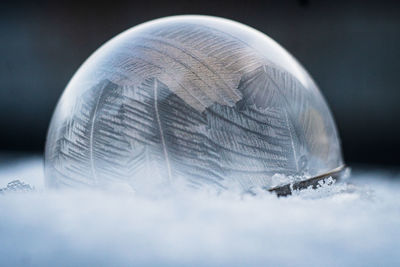 Close-up of crystal ball on snow