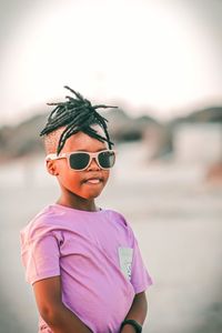 Portrait of young man wearing sunglasses against sky