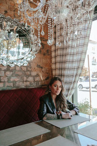 Portrait of smiling woman sitting on table
